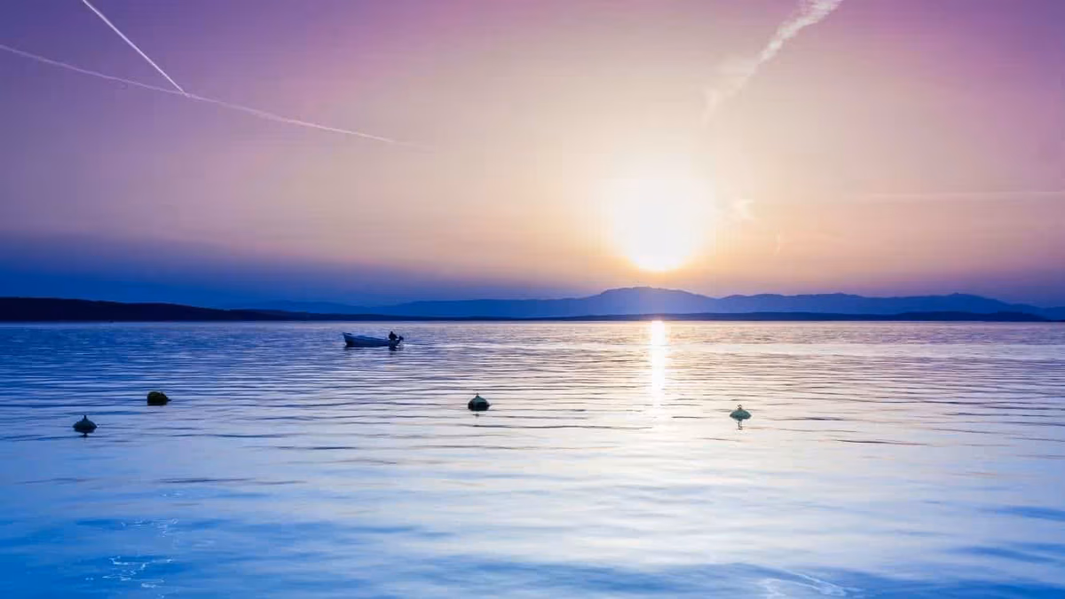 Adriatic Sea at sunset off the Croatian coast with a small boat.