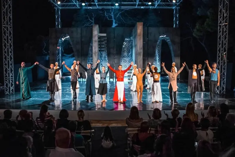 People on a stage preforming balet show