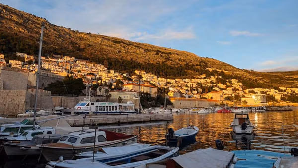 Cavtat to Dubrovnik ferry boat docked at the pier with passengers boarding.