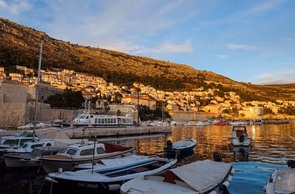 Cavtat to Dubrovnik ferry boat docked at the pier with passengers boarding.