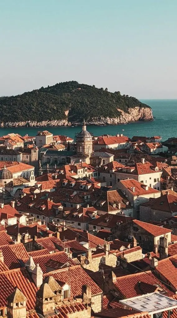 View from Dubrovnik City Walls over red-tiled Old Town and the sea.