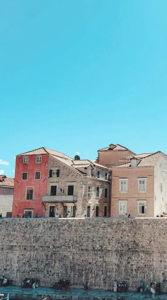 Guided City Walls tour with colorful Old Town houses and rooftops.