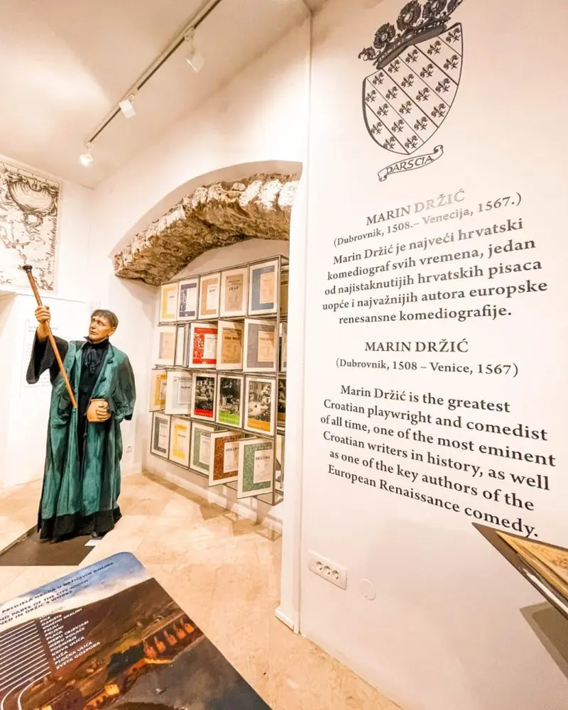 Lobby of the Marin Držić House museum with theater props and displays.