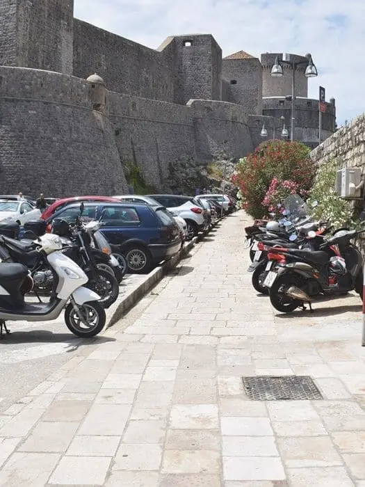 Scooter parked in a marked motorcycle bay near Dubrovnik Old Town.