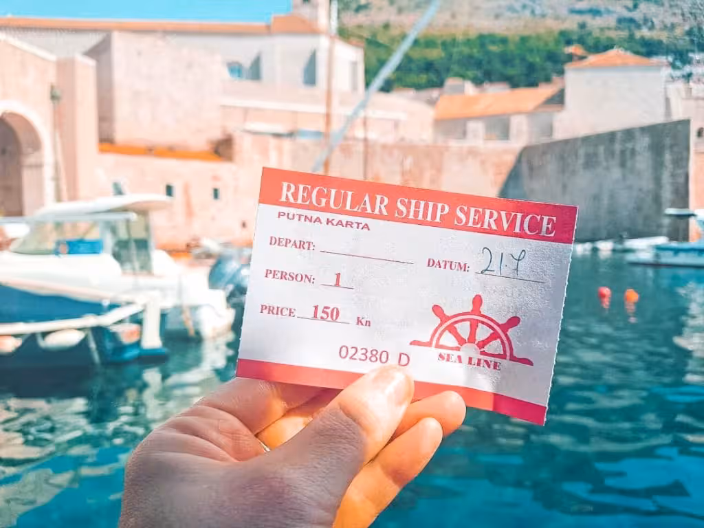 Hand holding a Sea Line ferry ticket for Cavtat to Dubrovnik route.