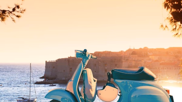 Scooter parked at a Dubrovnik viewpoint above Old Town and the sea.