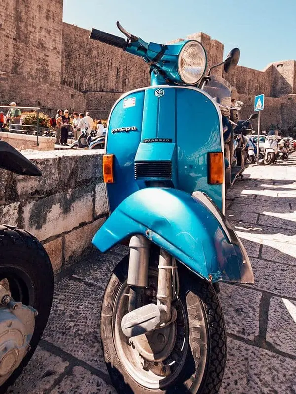 Scooter rental shop in Dubrovnik with bikes lined up outside.