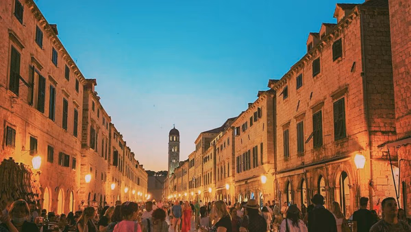 People walking along Stradun in Dubrovnik Old Town.