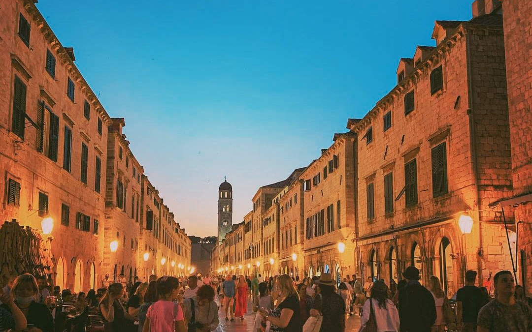 People walking along Stradun in Dubrovnik Old Town.