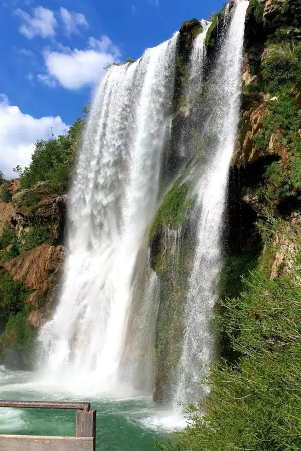 Krčić Waterfall spilling over a travertine ledge into a rocky basin.