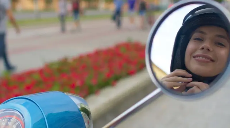 Open-face helmets and gloves on a scooter seat.