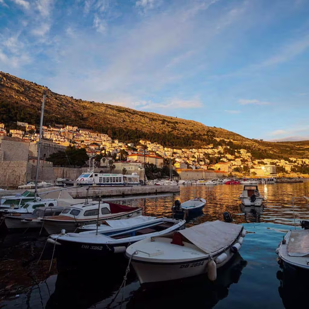 Cavtat to Dubrovnik ferry boat docked at the pier with passengers boarding.