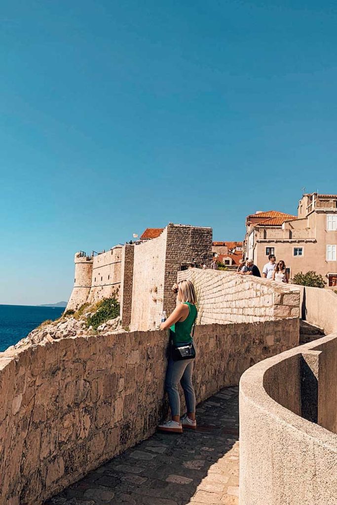 Person standing in a narrow walkway.