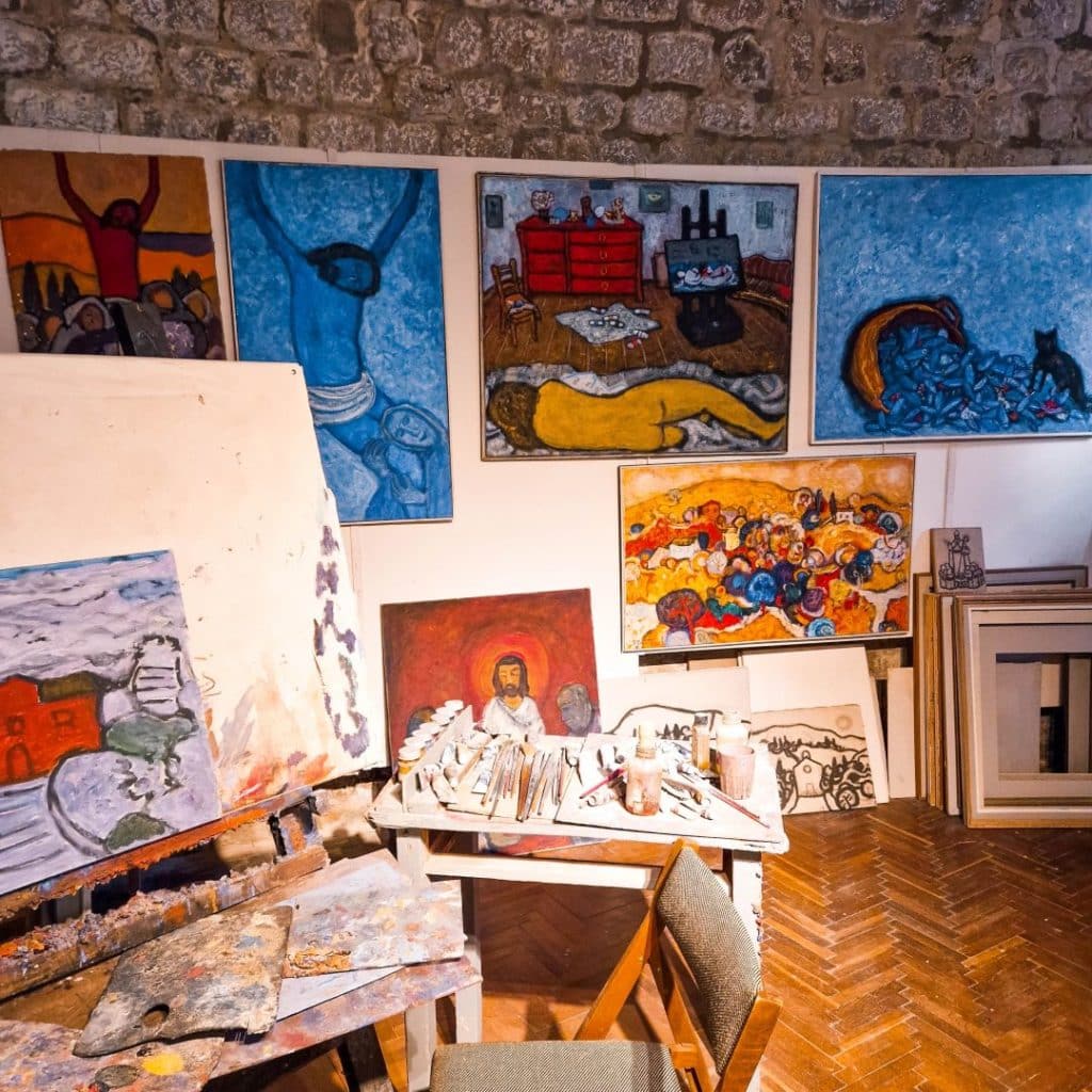 Inside the Atelier Pulitika Studio with paintings and the artist's tools.