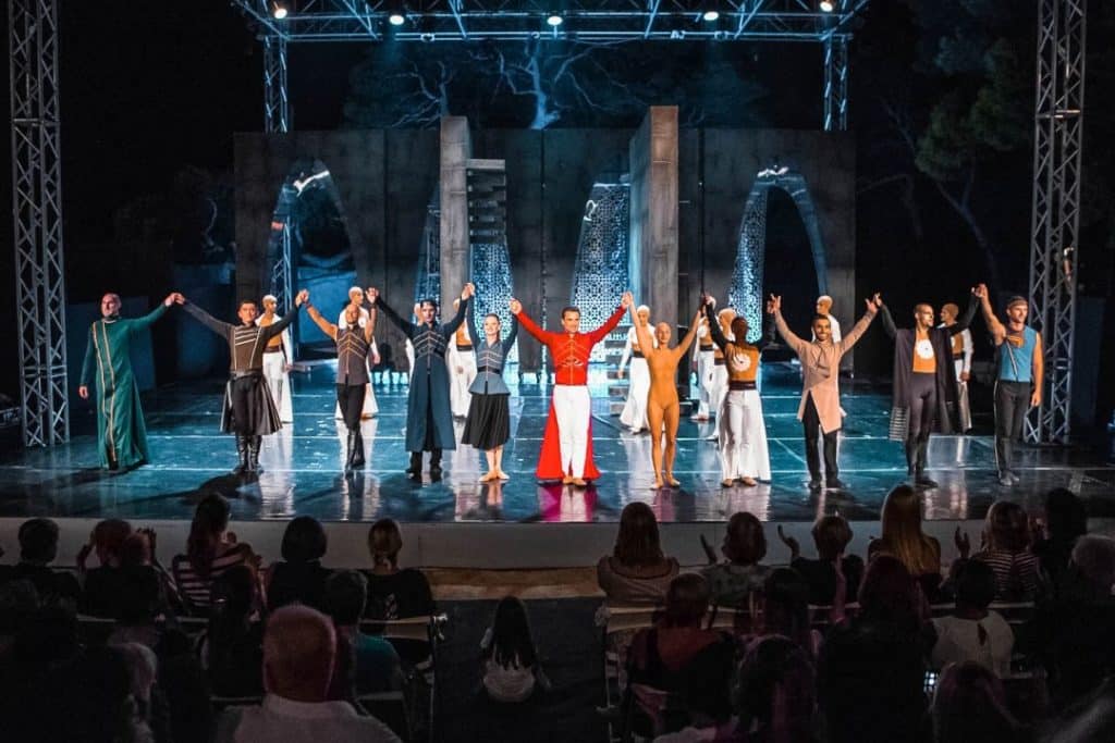 People on a stage preforming balet show