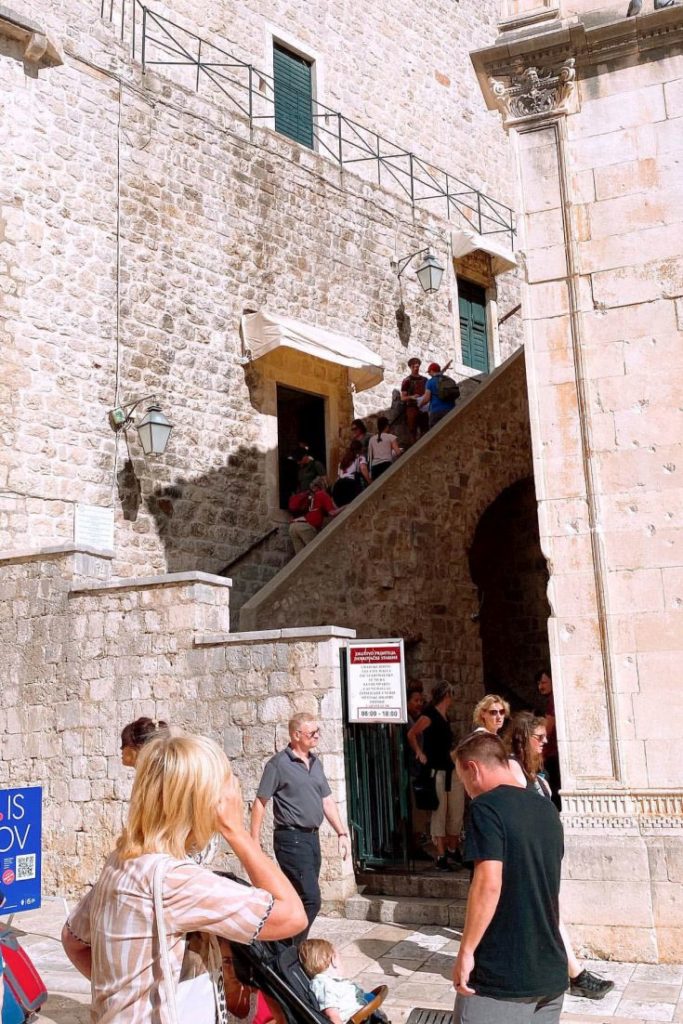 Pile Gate entrance to Dubrovnik City Walls with visitors in line.