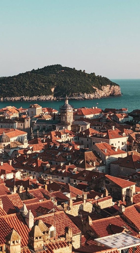 View from Dubrovnik City Walls over red-tiled Old Town and the sea.