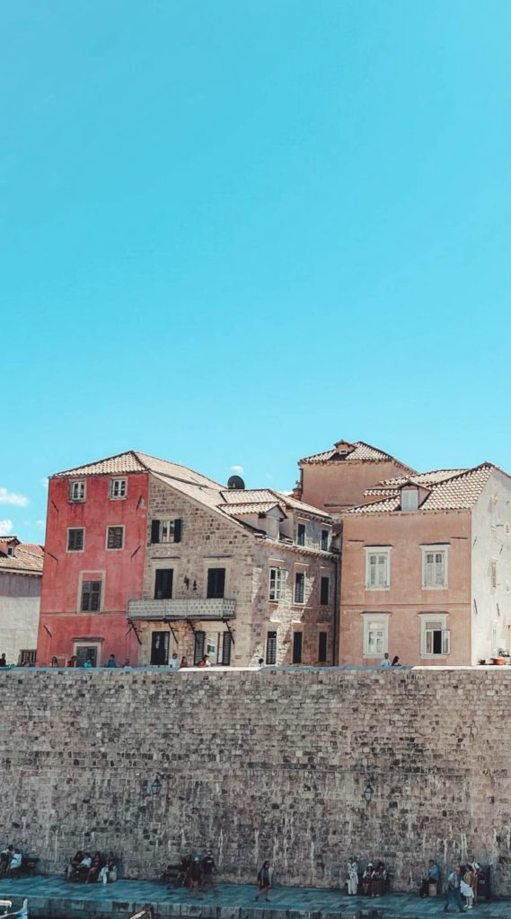 Guided City Walls tour with colorful Old Town houses and rooftops.