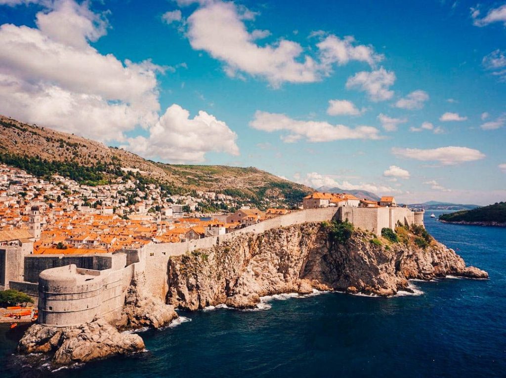 Close view of Dubrovnik's stone city walls with towers and battlements.