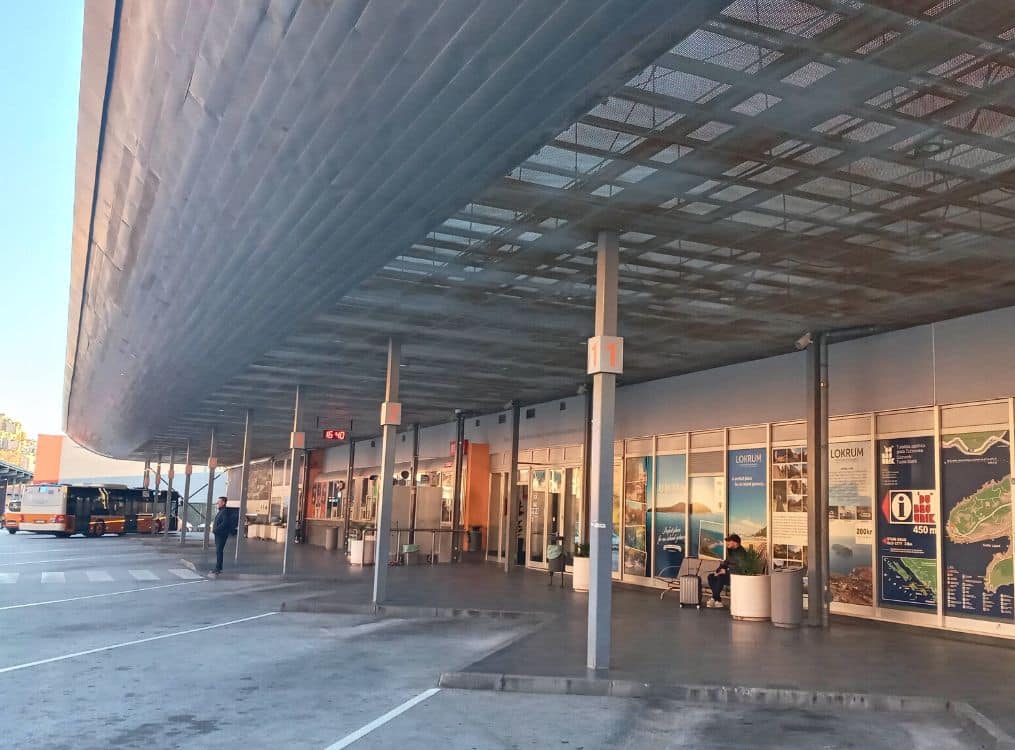 Exterior view of Dubrovnik Main Bus Station at Gruž harbour, with departure shelters and buses