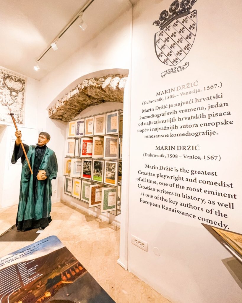 Lobby of the Marin Držić House museum with theater props and displays.