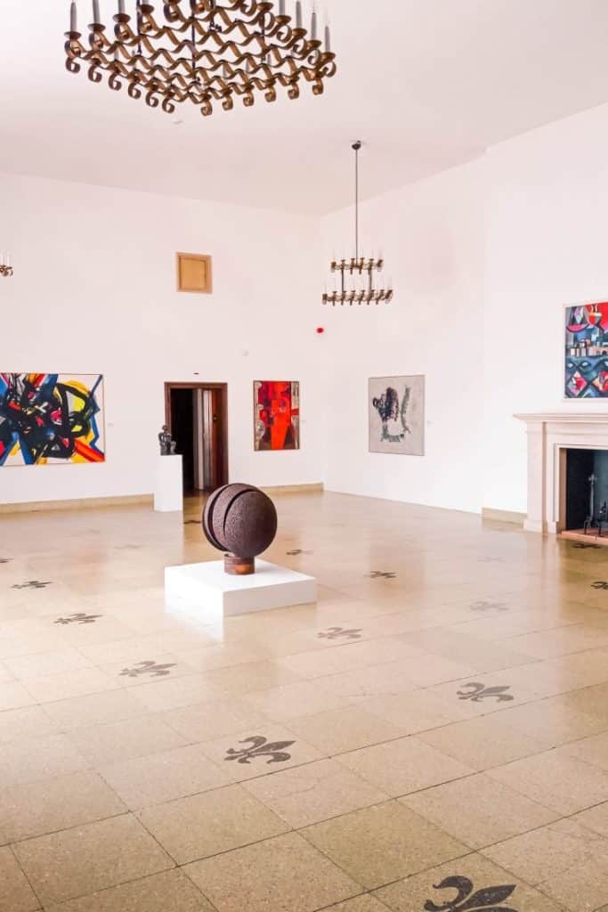 Contemporary sculptures and paintings in the museum gallery.