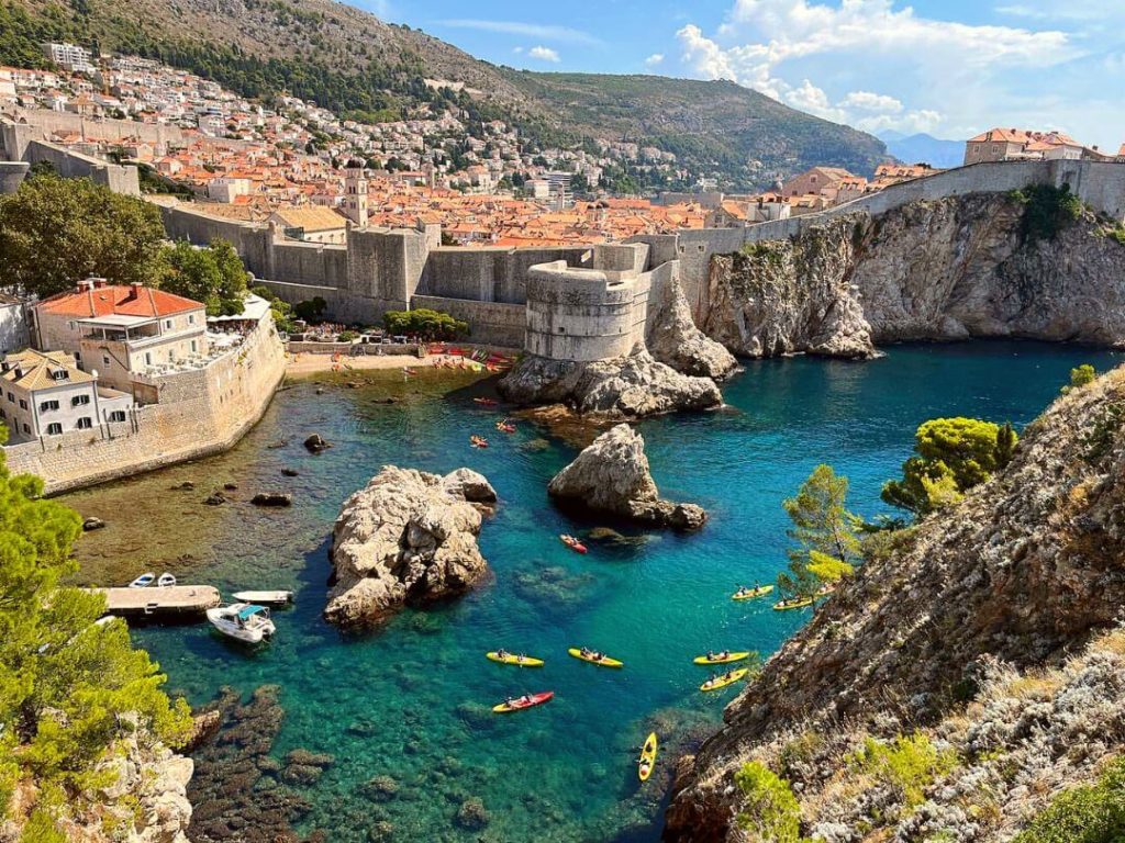 Dubrovnik Old Town and sea kayaks leaving Pile Bay seen from Lovrijenac