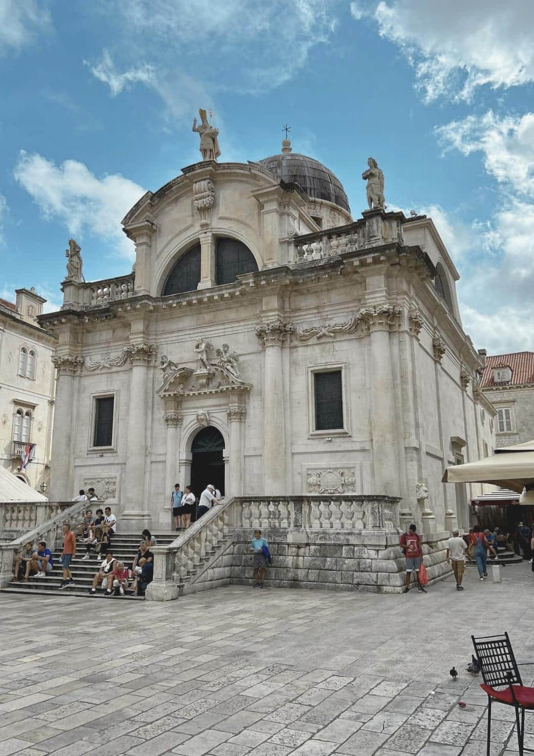 Photo of Saint Blaise church in Dubrovnik with people taking a photo infront