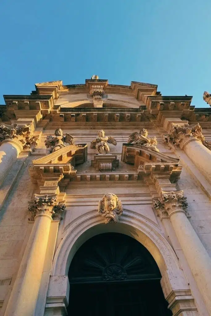 Close up on the statues on top of St. Blaise church