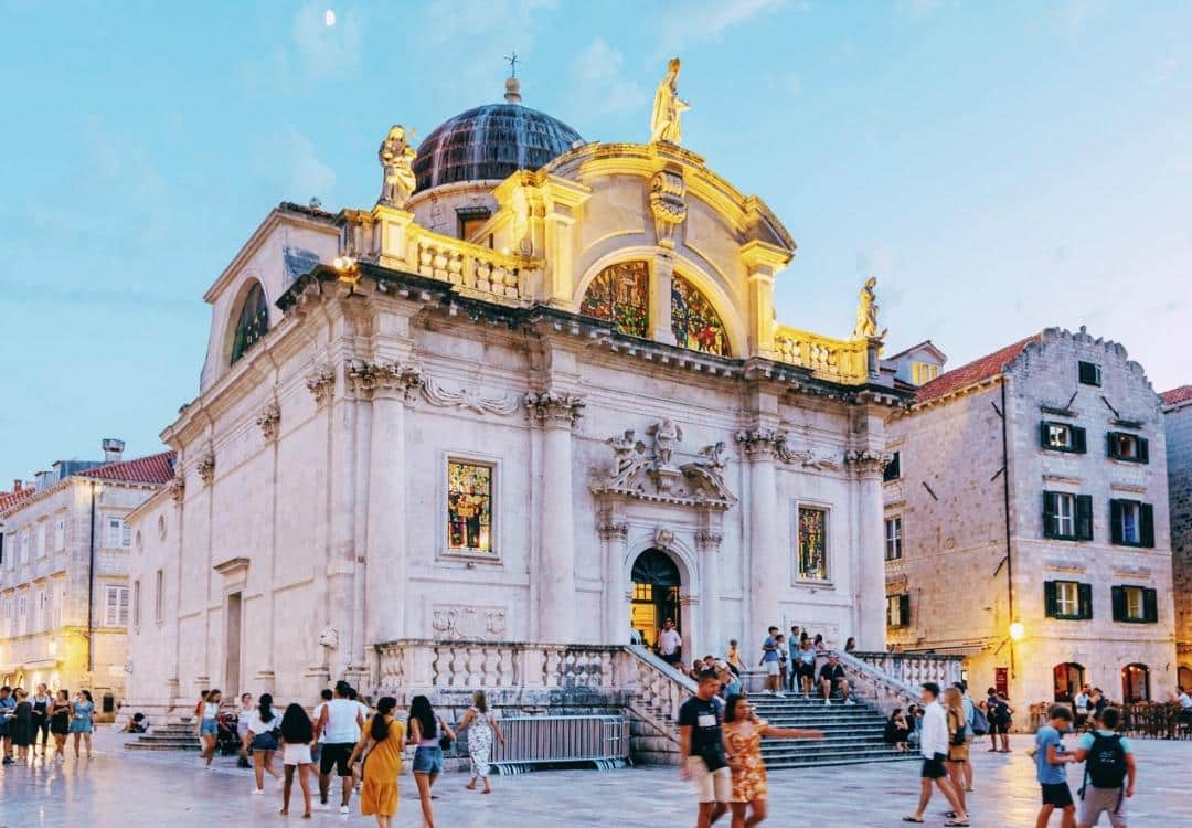 Image of Saint Blaise church Dubrovnik in dusk with people walking around