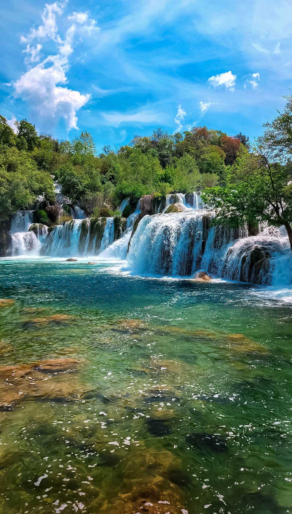 Skradinski buk is a waterfall surrounded by nature, offers trails & viewing areas plus a swimming spot.
